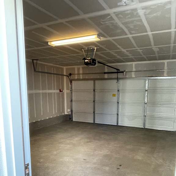 a bathroom with a walk-in shower and a concrete floor.