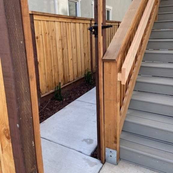 a wooden gate is open to a staircase.