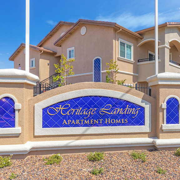 a large building with a sign in front of it at heritage landing apartments, chico, ca, 95973