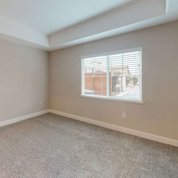 an empty bedroom with a white door and a window at heritage landing apartments, chico, california
