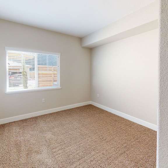 an empty room with carpet and a window at heritage landing apartments, chico, ca
