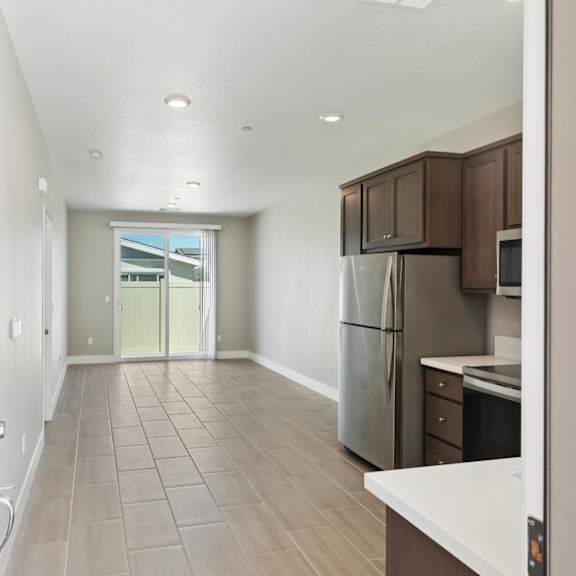 a long hallway with a kitchen area at the end at montessa apartments, vacaville