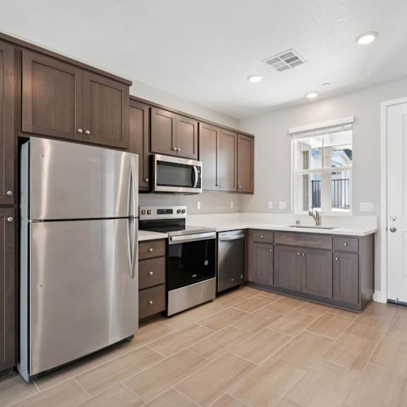 a kitchen with a refrigerator at montessa apartments, california, 95687