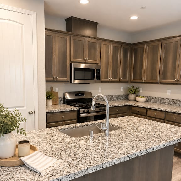 a kitchen with a granite countertop and wooden cabinets.