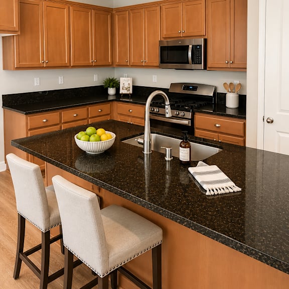 a kitchen with wooden cabinets and black countertops.