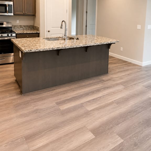 a kitchen with a microwave and oven built into the cabinetry.