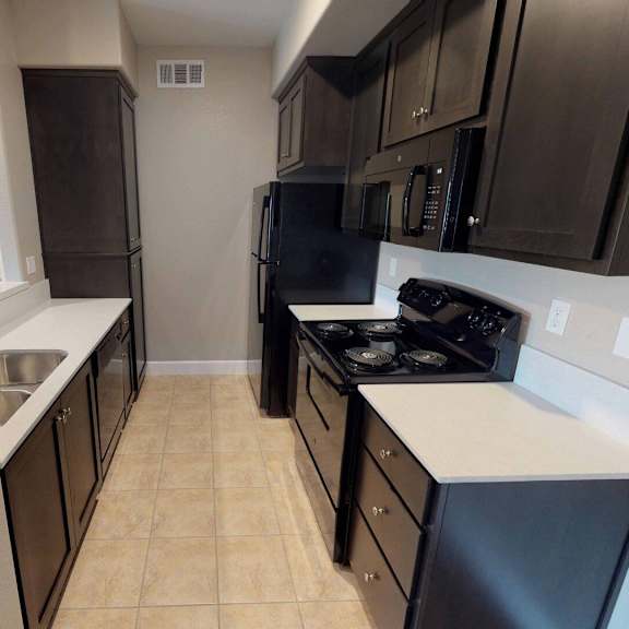 a kitchen with black appliances and white counter tops at edgewater, california  