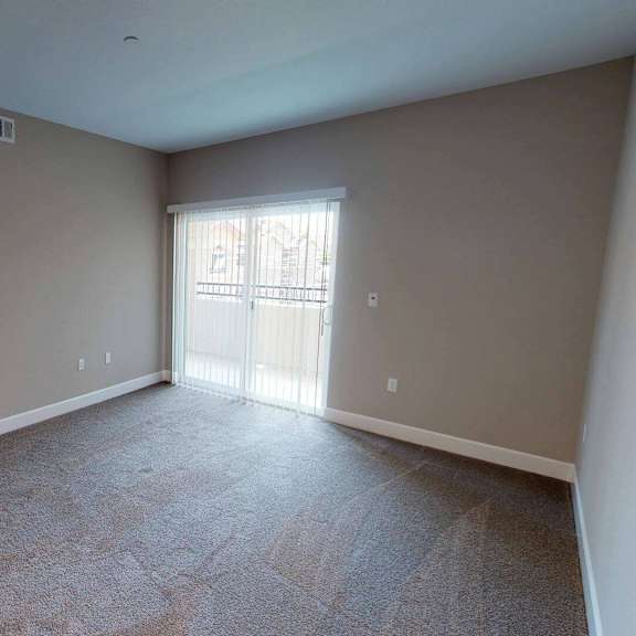 the living room of an empty house with gray walls and a window at edgewater, pittsburg, ca 94565  