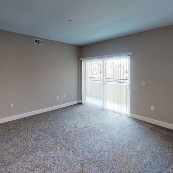 an empty living room with a sliding glass door at edgewater, california, 94565