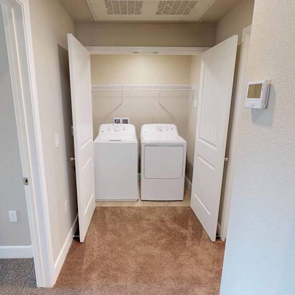 a laundry room with two washers and dryers in it at edgewater, pittsburg, 94565  