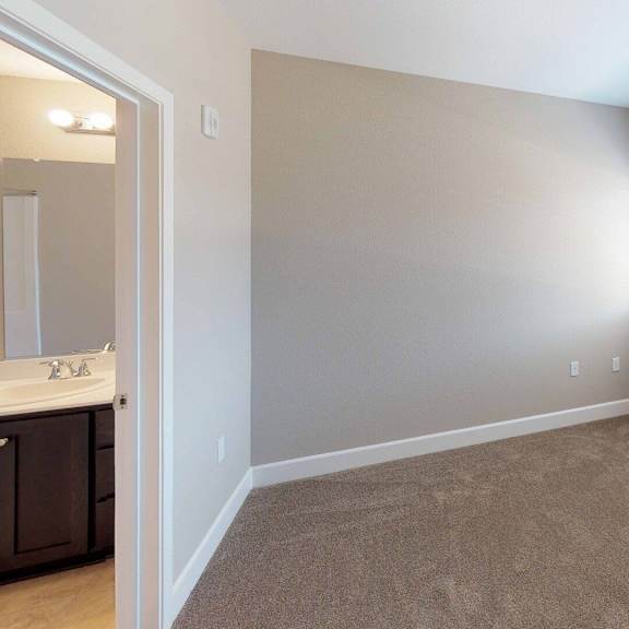 an empty bedroom with a large window and a sink at edgewater, california  