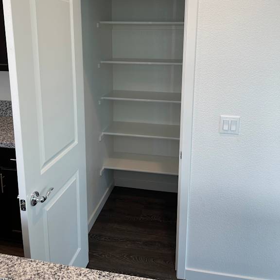 a white cabinet with a glass door and a drawer.