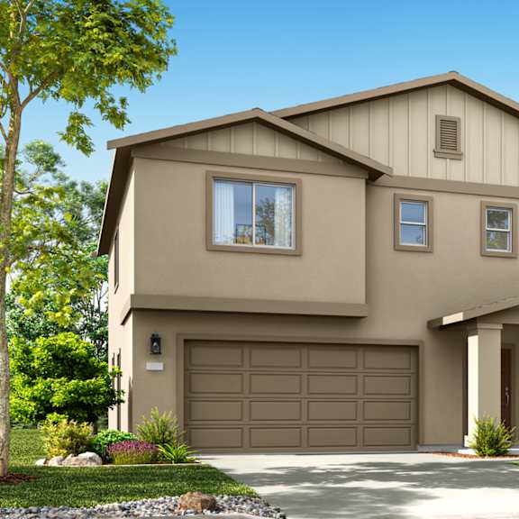 a two-story house with a garage is surrounded by a well-manicured lawn and trees.