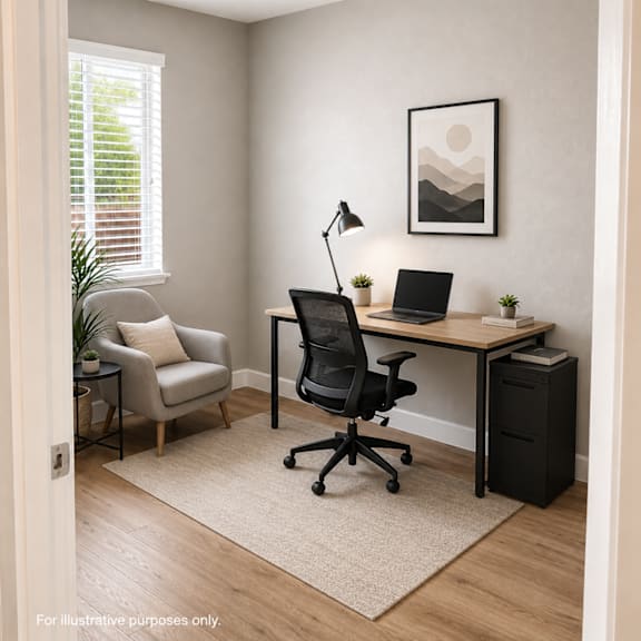 a room with a desk, chair, and a plant.