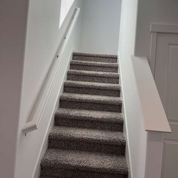a white shelf with a grey curtain in the background.