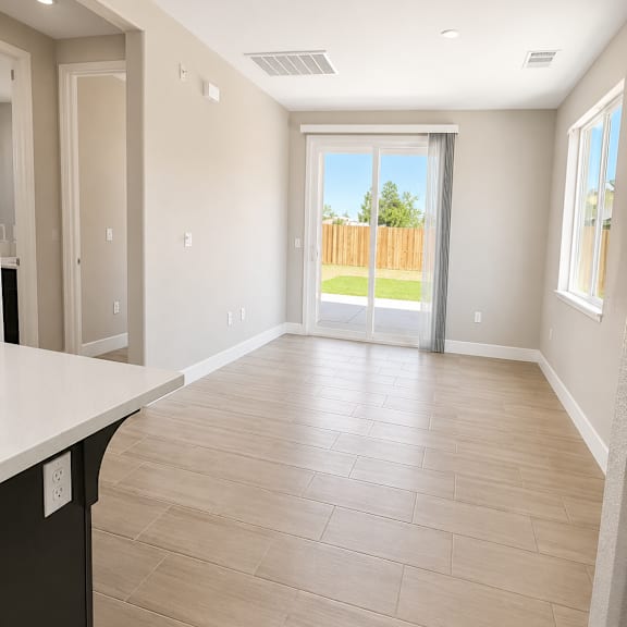 a room with a sliding glass door leading to a backyard.