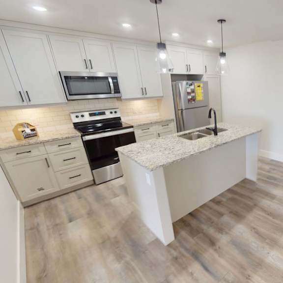 a kitchen with a stove top oven and a microwave.