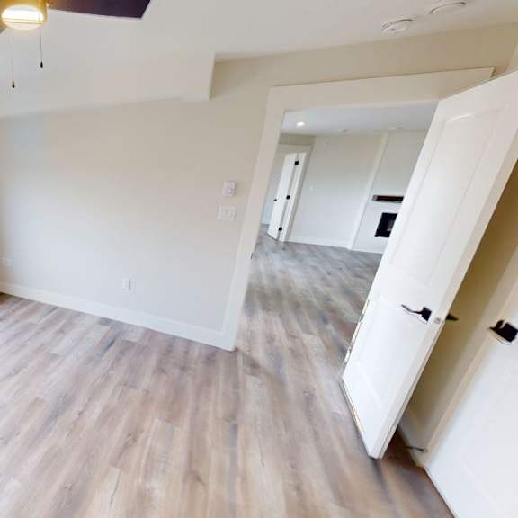 a room with a window and a ceiling fan.