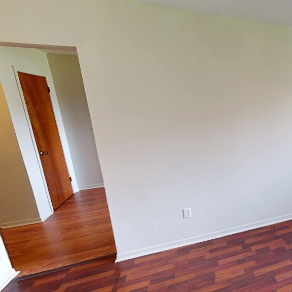 a room with a wooden floor and a window.