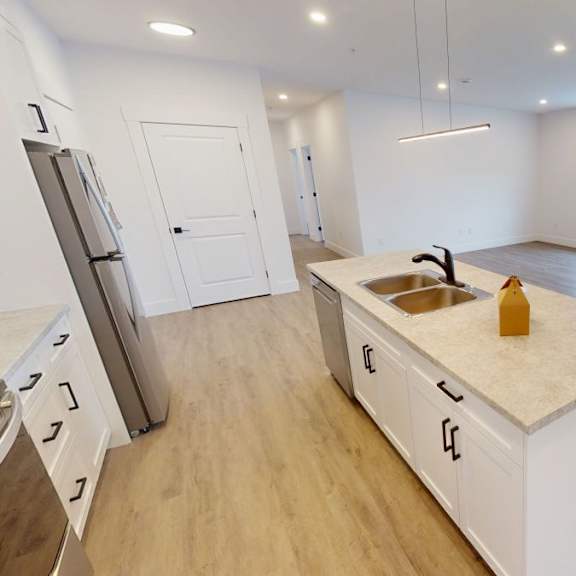 a kitchen with white cabinets and a wooden island.