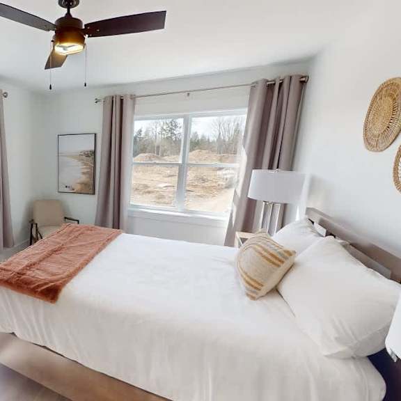 a bedroom with a large bed and a ceiling fan.