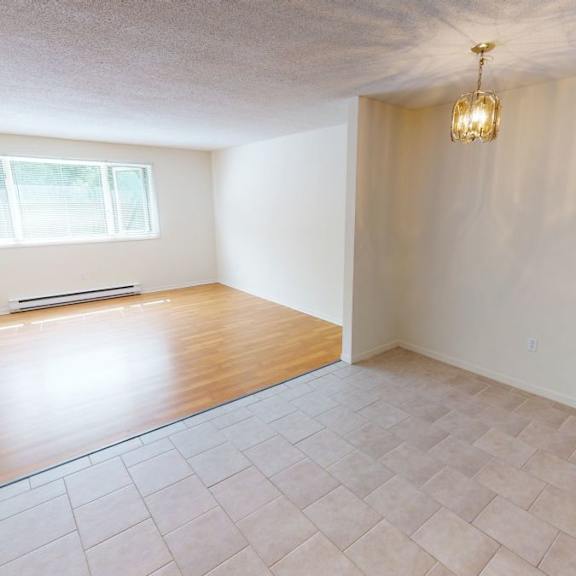 a room with a window and a wooden floor.