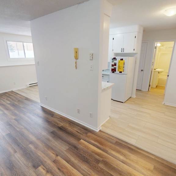 a room with wooden floors and white walls.