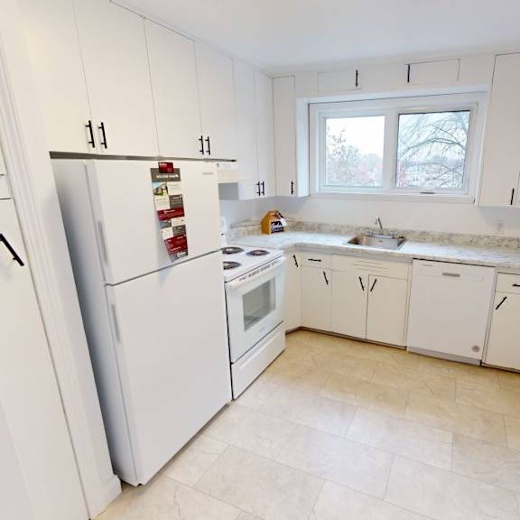a kitchen with white appliances and cabinets.