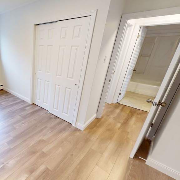 a room with a wooden floor and a white door.