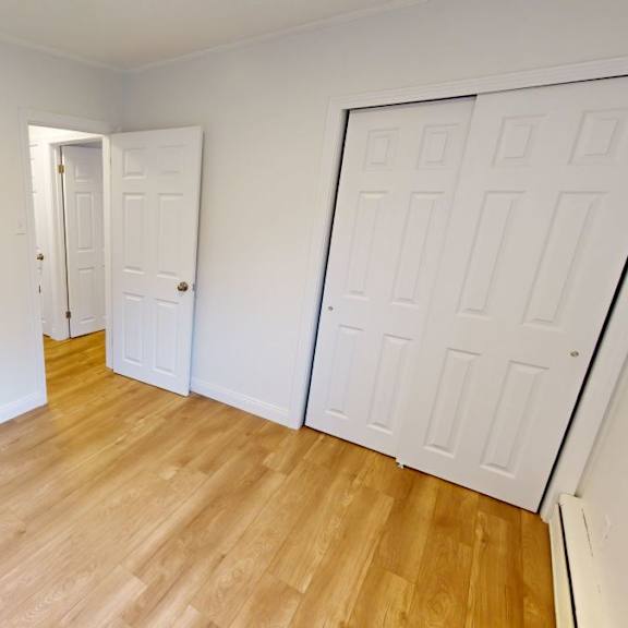 a room with a white door and a white closet door.