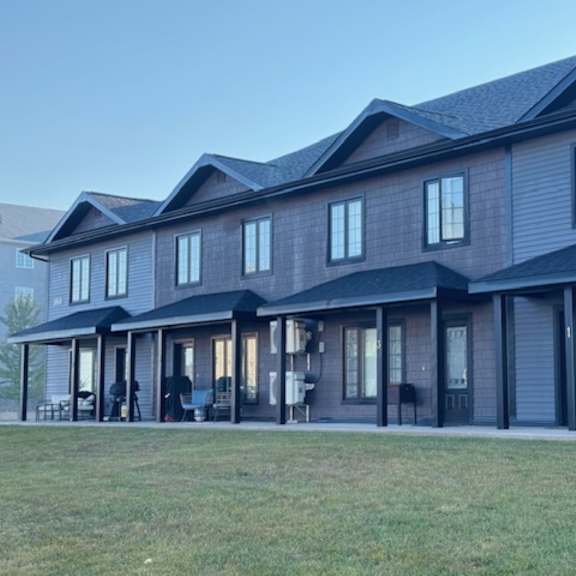 a large house with a dark grey exterior and multiple windows.