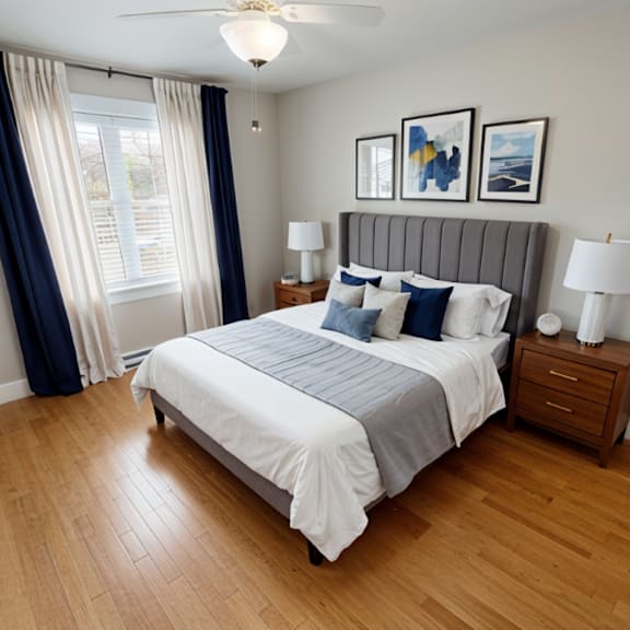 a bedroom with a bed, nightstands, and pictures on the wall.