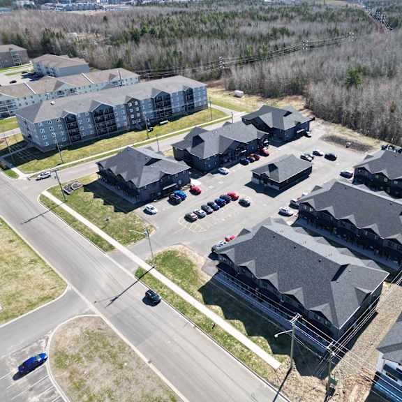 a bird's eye view of a residential area with houses and cars.