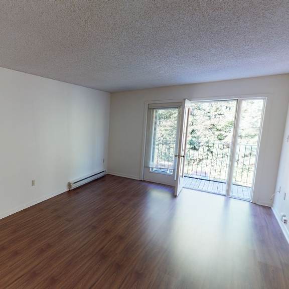 a room with wooden floors and white walls.
