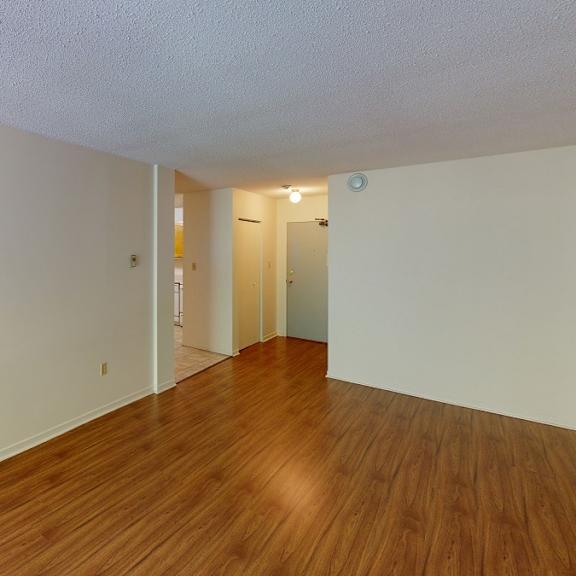 a room with wooden floors and white walls.