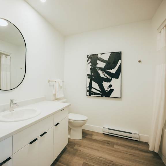a bathroom with a white sink and toilet.