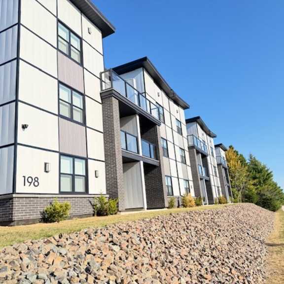 a modern apartment building with the number 198 on the front.
