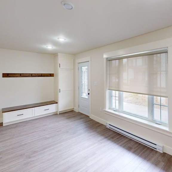a room with a window and a bench under a window.
