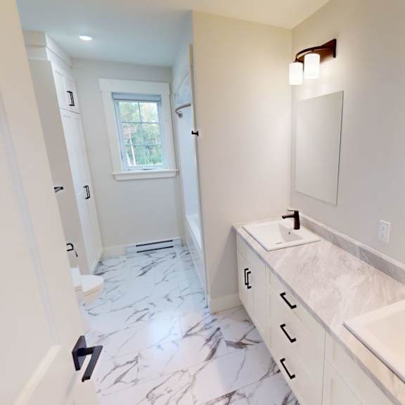 a bathroom with a marble floor and white walls.