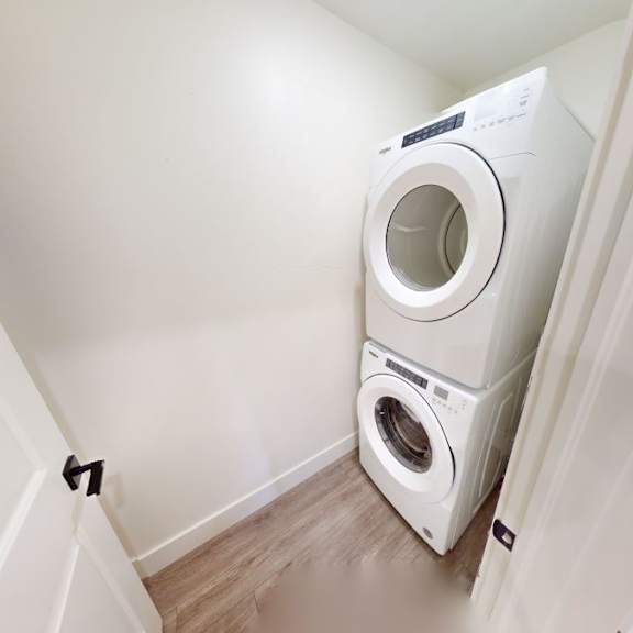 a white washing machine is in a small room.