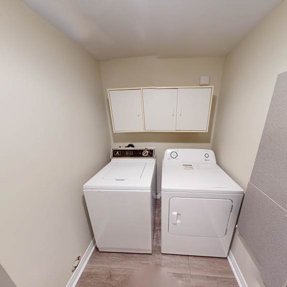 a small bathroom with a toilet and a washing machine.