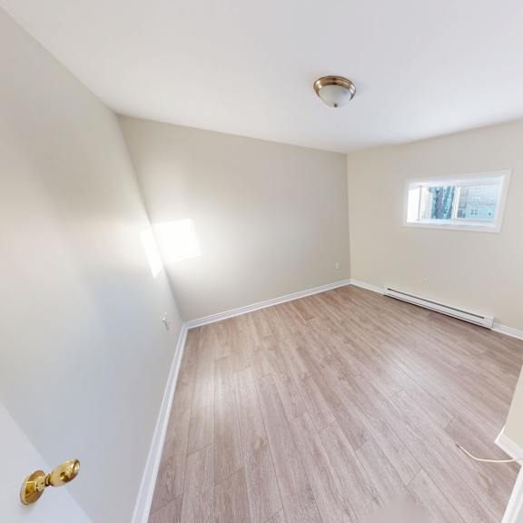 a room with a wooden floor and a window.