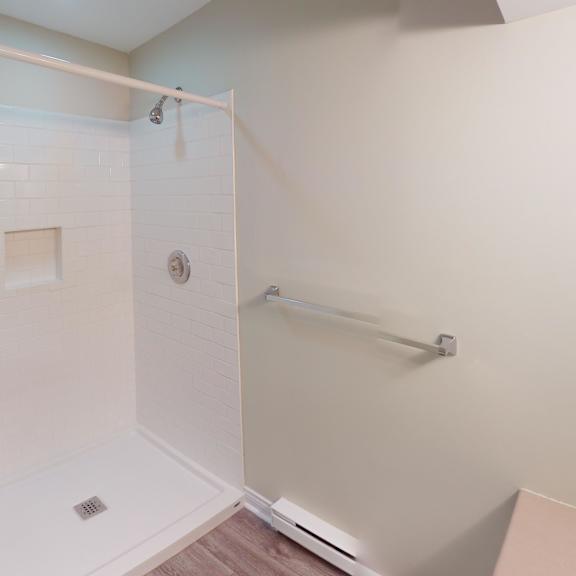 a white bathroom with a walk-in shower.