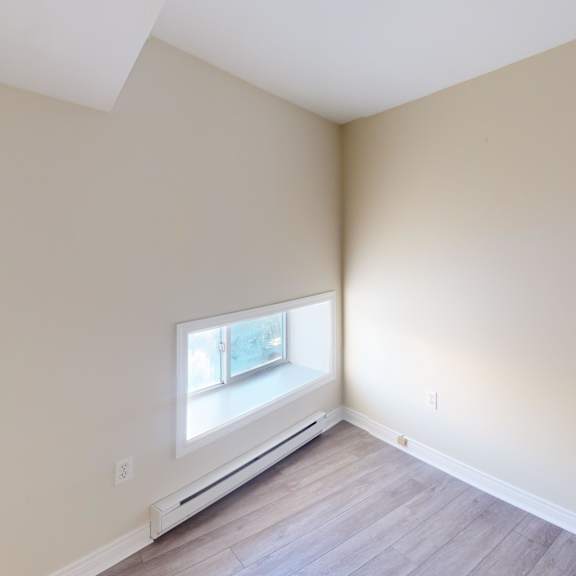 a room with a window and a white ceiling.