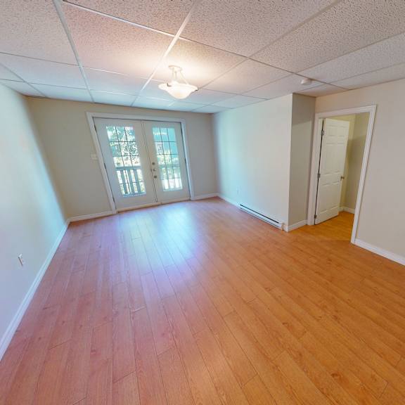 a room with wooden floors and a window.