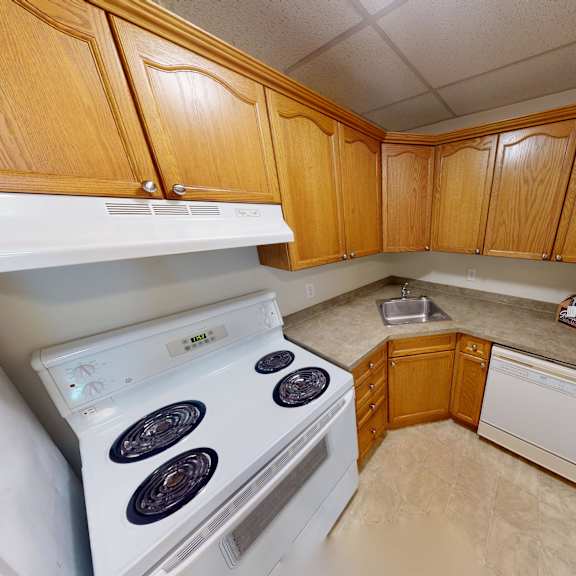 a small kitchen with a stove and a dishwasher.