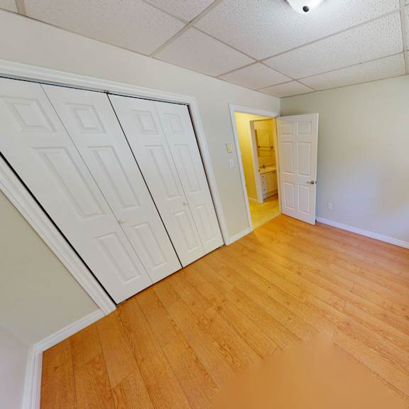 a room with a wooden floor and white walls.
