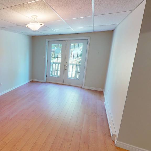 a room with wooden floors and a white door.