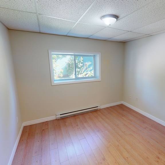 a room with wooden flooring and a window.