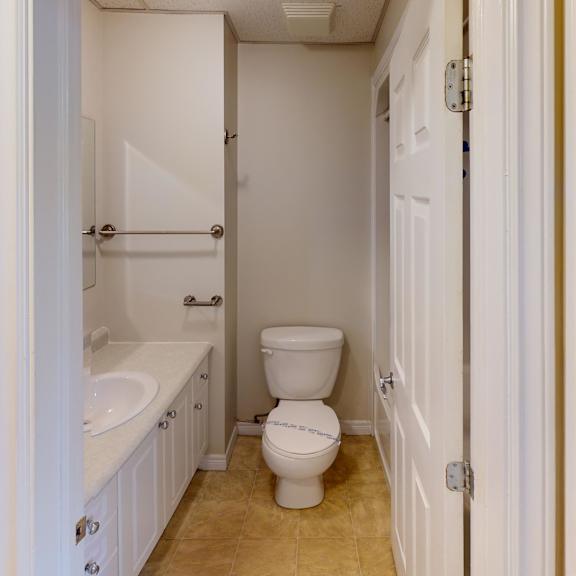 a white bathroom with a toilet, sink, and bathtub.